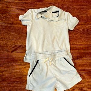 Minnow swim terry set 3/4T in light blue with navy pipping on pockets on shorts.